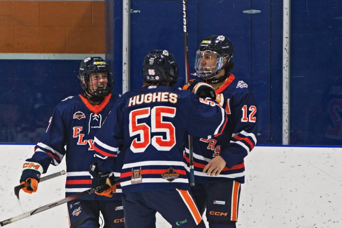 McCallum Bakken (left), Lucas Hughes (centre) and Isaac Cayetano (right), come together for some hockey hugs. (Scott Savard/High River Flyers)