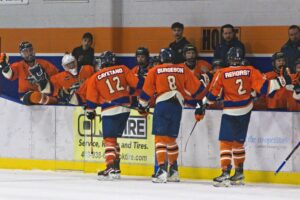 Isaac Cayetano, Ethan Burgeson, and Wout Rehorst giving out fist bumps after a goal. (Scott Savard/High River Flyers)