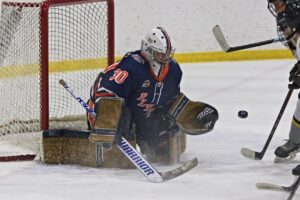 Erich Baxter tracking a puck after making a save in a game last season. (Scott Savard/High River Flyers)